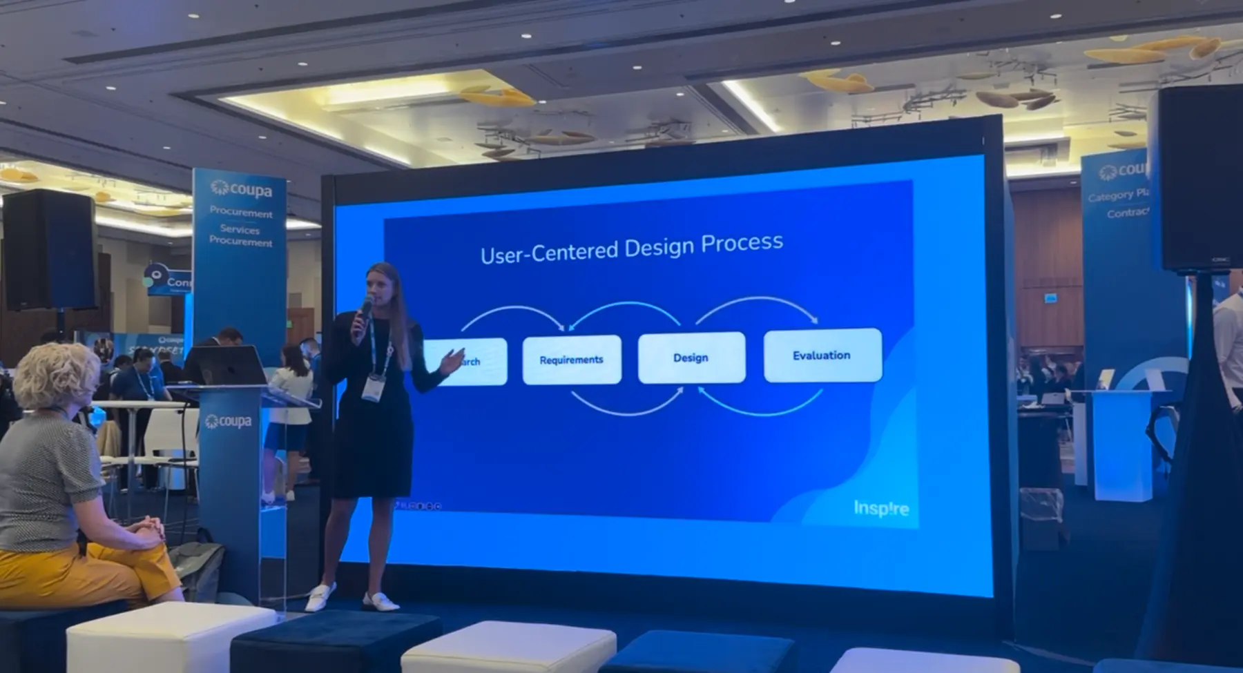 Sara presenting the user-centered design process in the Coupa Inspire expo hall